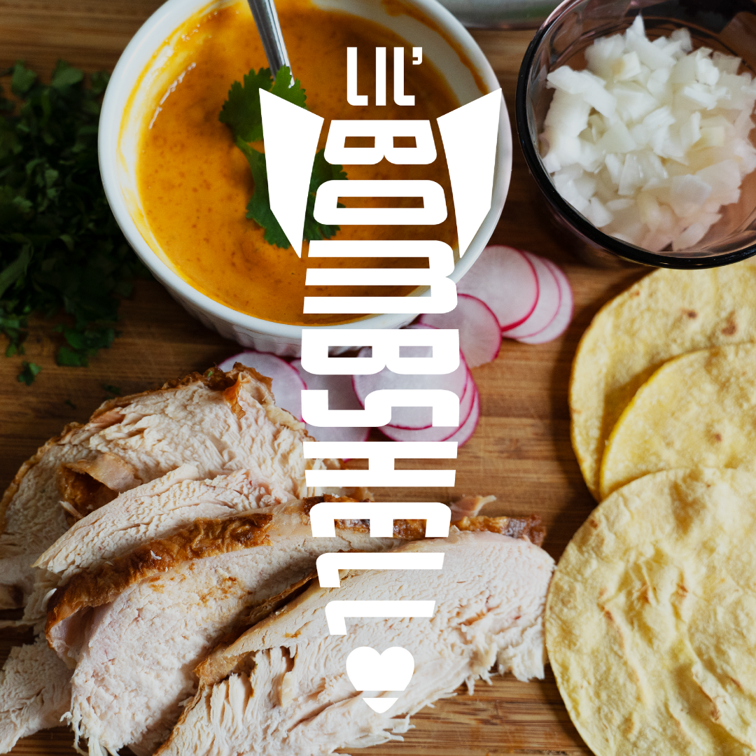 Wooden cutting board with sliced bread, tortillas, and a bowl of soup with 'Lil Bombshells' logo.