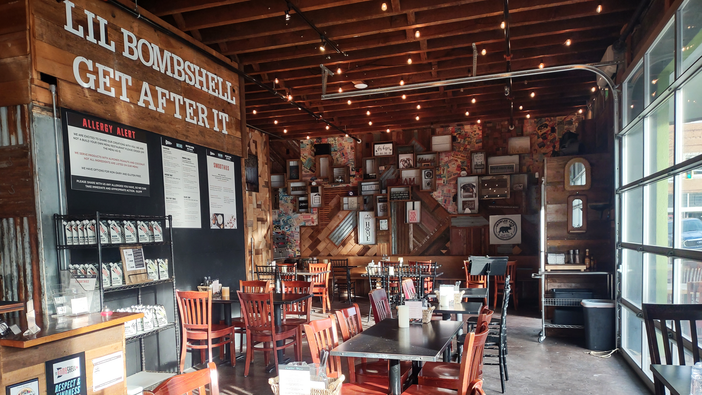 Image of the eatery in Lebanon Oregon with chairs, tables, and a sign on the wall that says "Lil Bombshell Get After It"