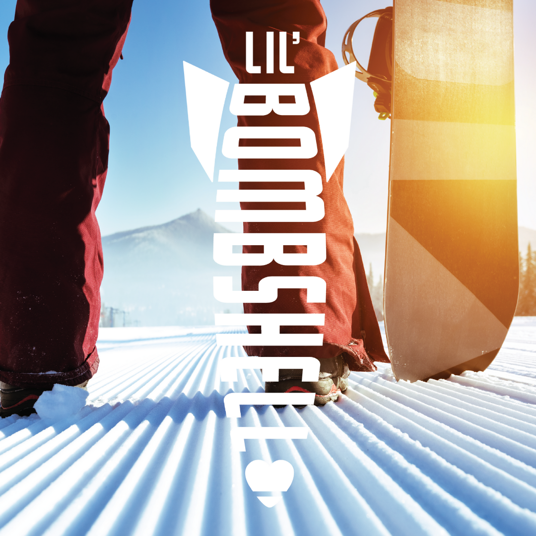 Snowboard and snow boots on a snowy surface, featuring the text 'LIL' BOMBSHELL'.